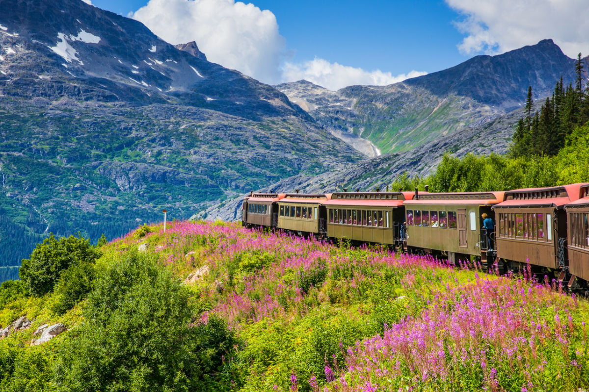 Alaska train passing through mountains in Skagway